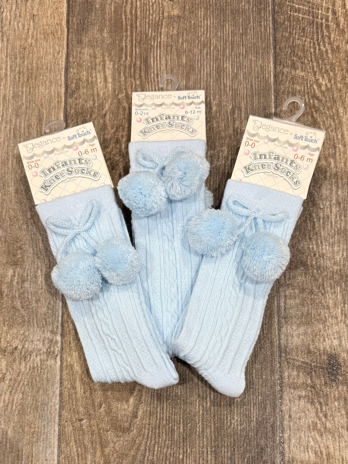 Baby blue knee high socks with pom poms