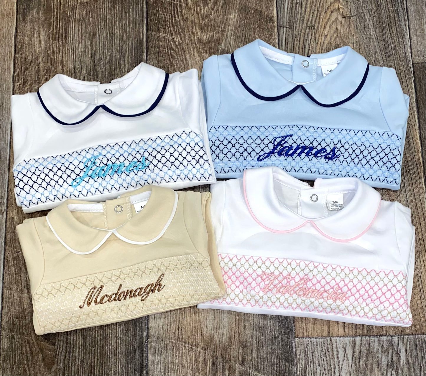 close up of 4 Soft cotton personalised baby sleepsuit in traditional colours