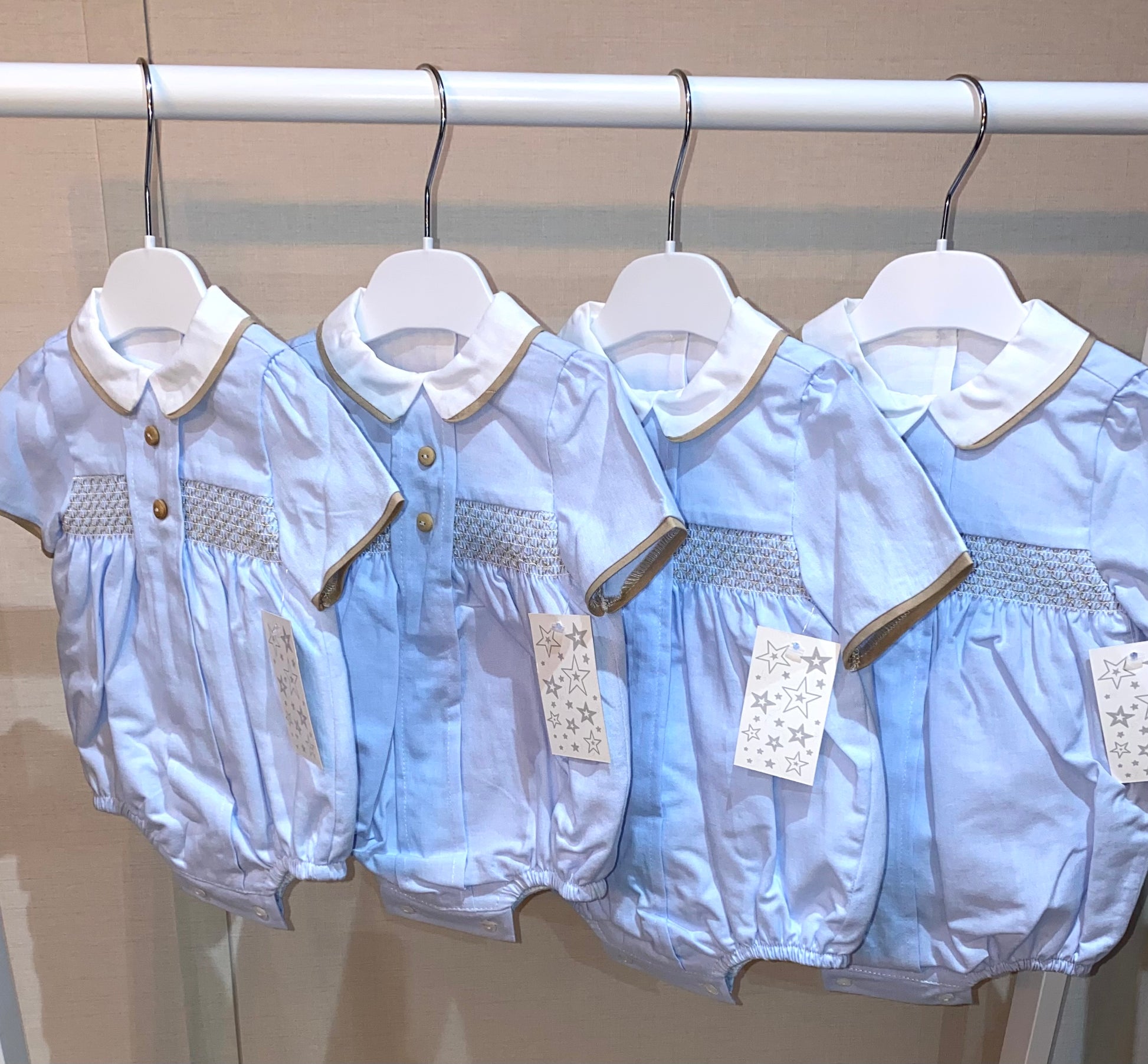 Blue smocked baby romper with Peter Pan collar
