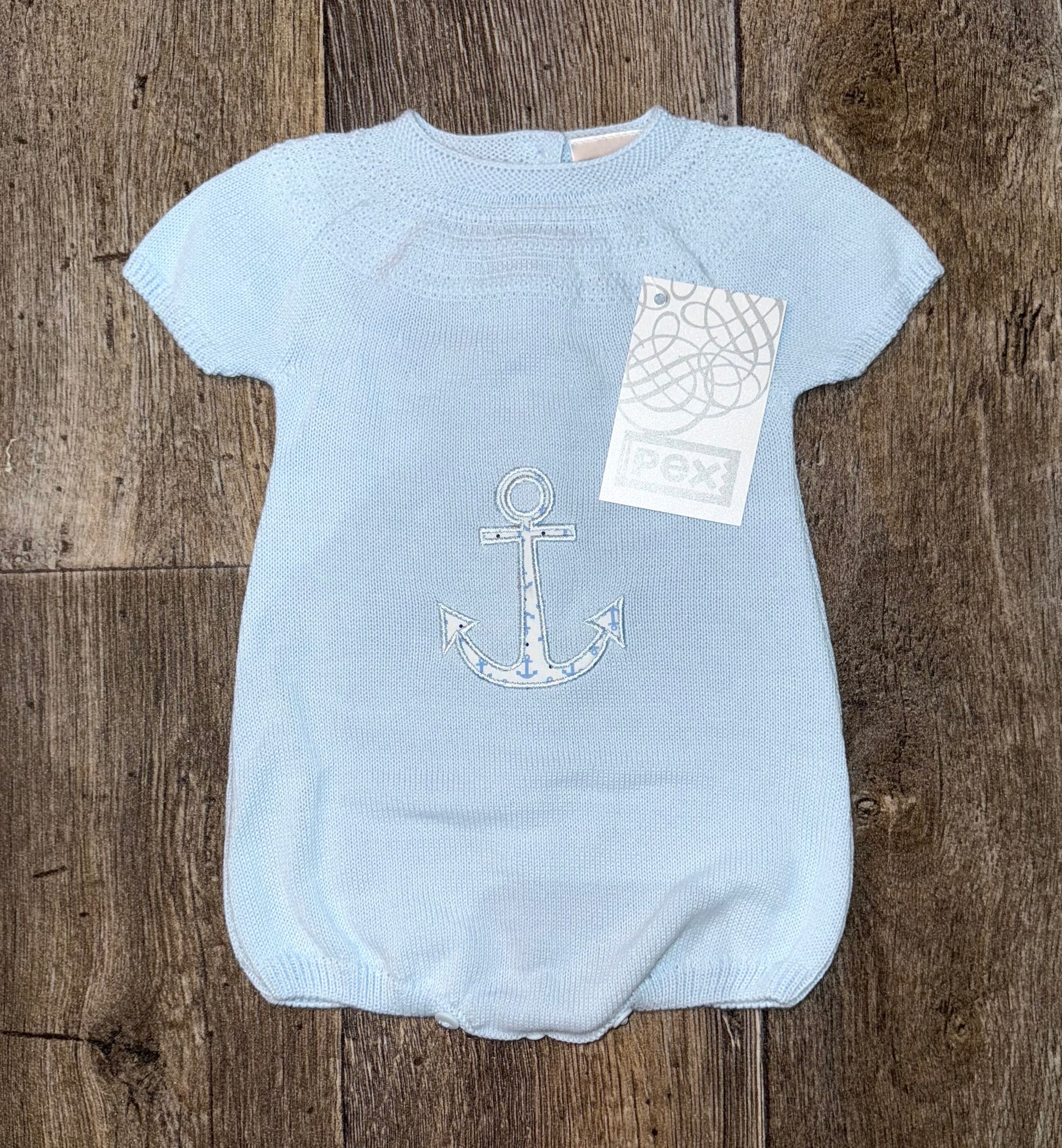 Pex blue knit romper, with anchor detail on front