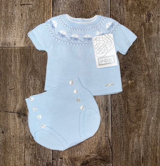 Light blue baby outfit with matching jam pants on a wooden surface