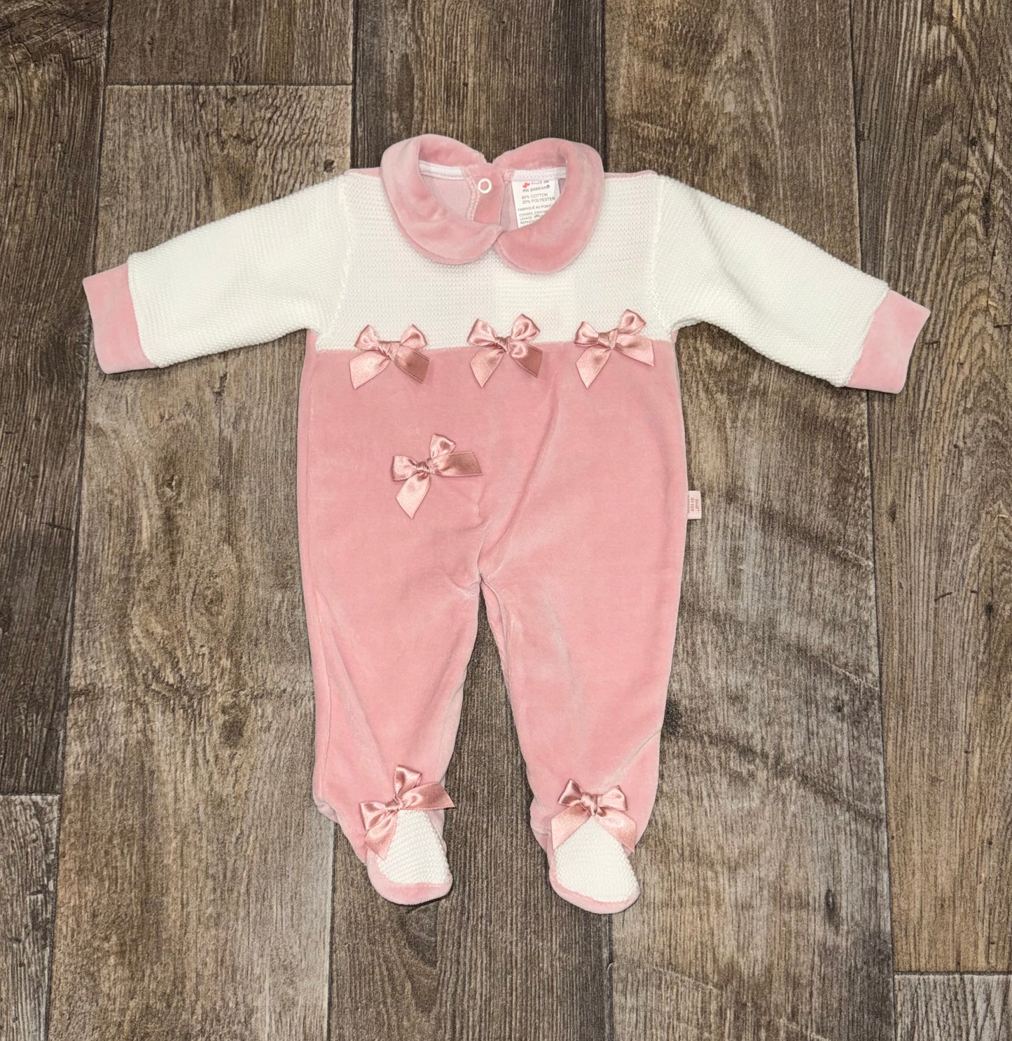 Traditional baby girl pink outfit with bow details