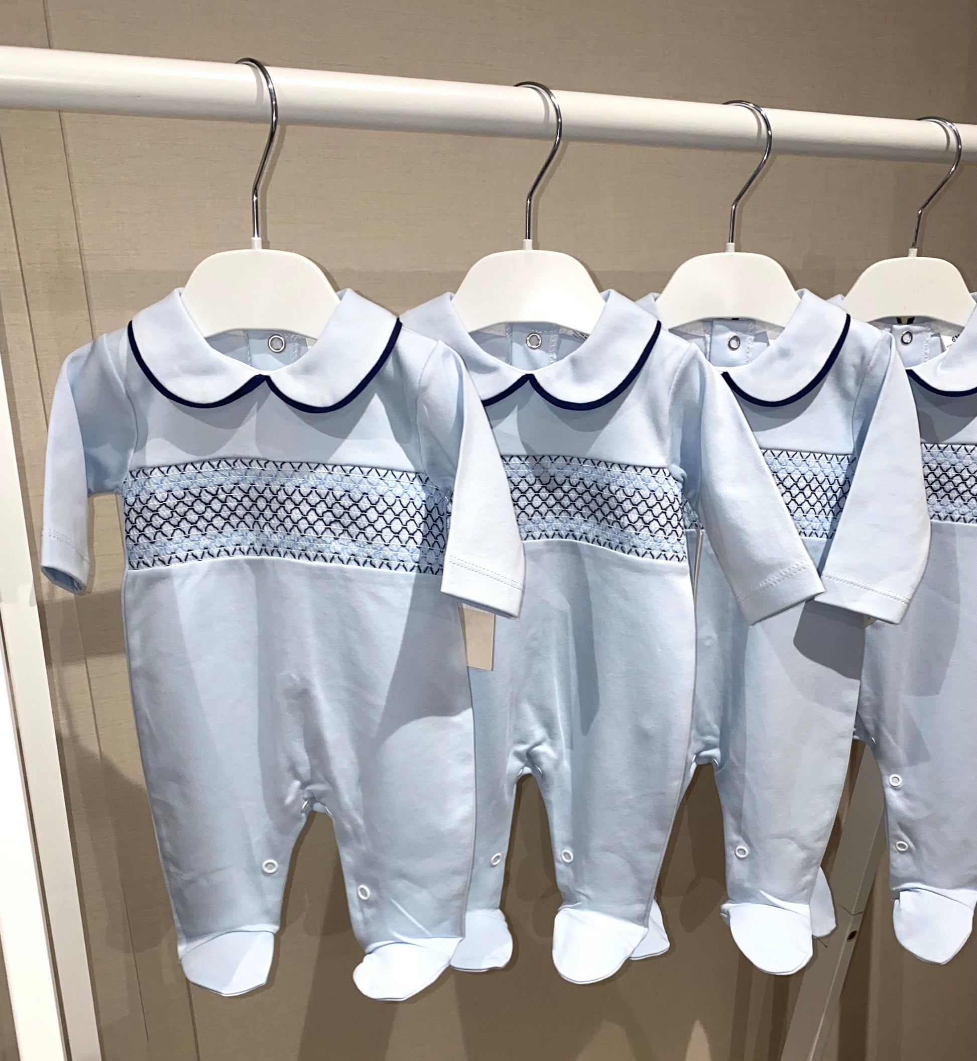 Soft cotton Spanish baby sleepsuit in blue with smocked details