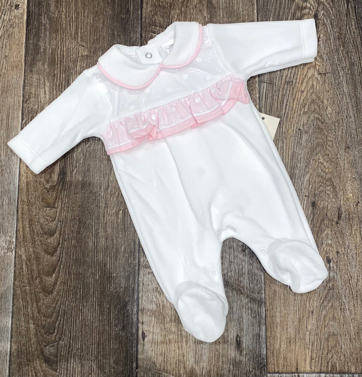 White baby girl sleepsuit with pink ruffle